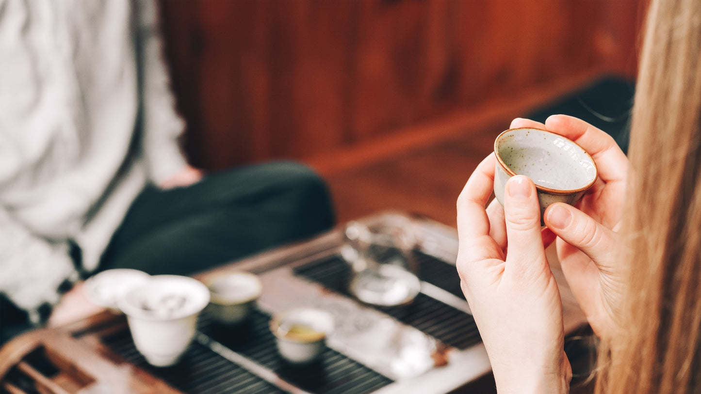 Person learning how to taste Pu-erh tea during a Gongfu tea session — exploring aroma, flavor, and Cha Qi in traditional Chinese tea culture.
