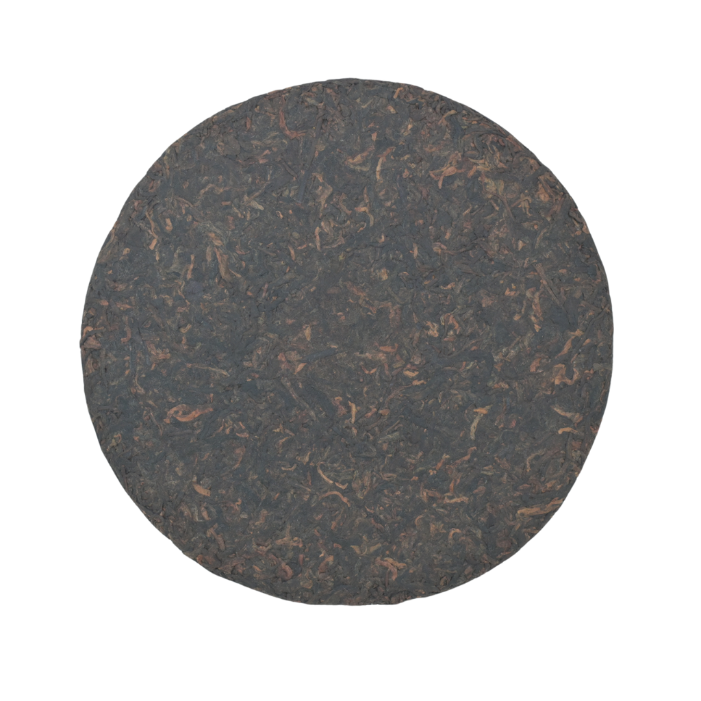 Tea & Leaf Runye 2023 Yiwu Ancient Tree Ripe Pu-erh Tea Cake 357 g – close-up of fully unwrapped compressed Pu-erh cake showing rich aged tea leaves with reddish-brown tones, highlighting forest and rice aroma from Yunnan, China.