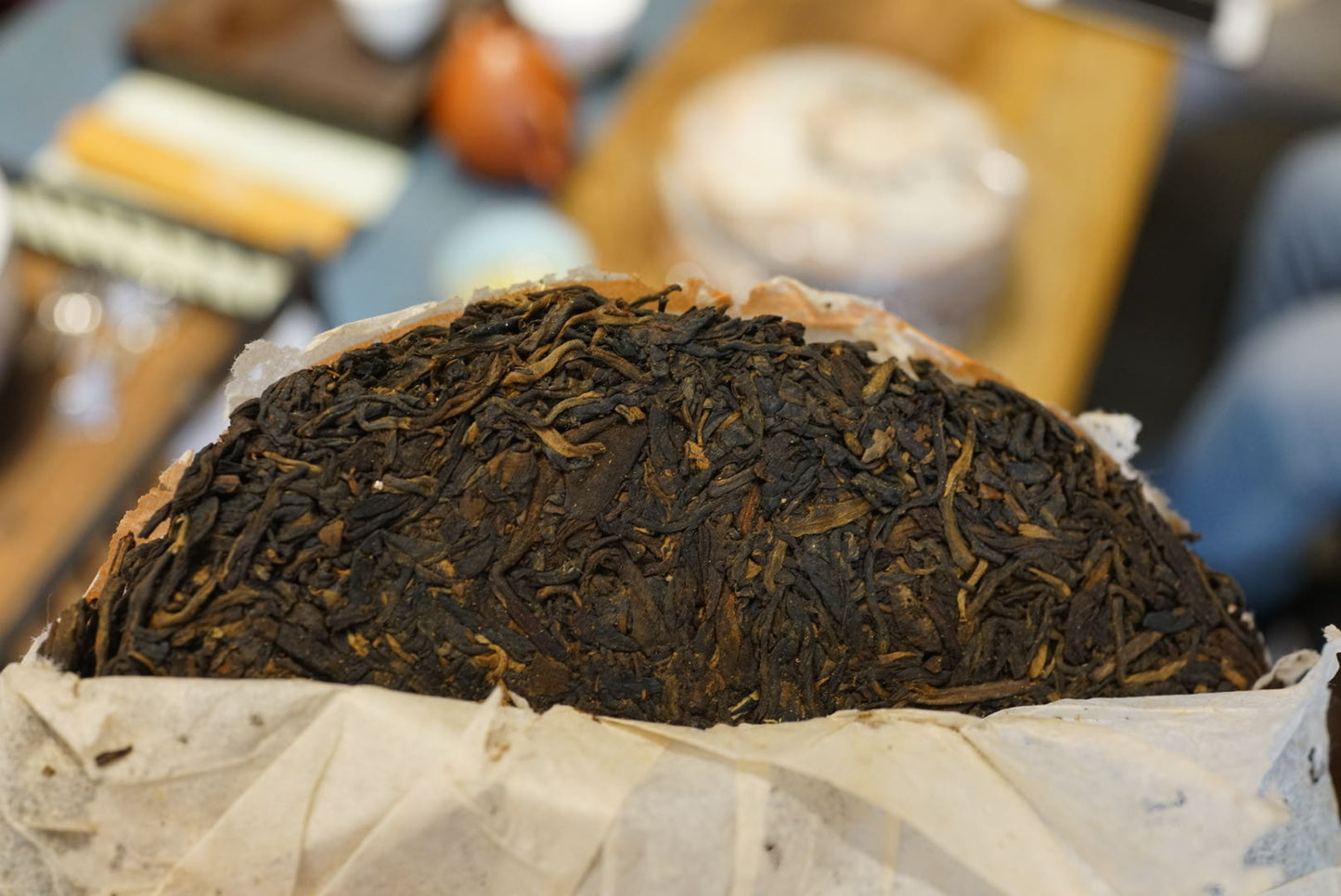 Close-up of 1999 Yichang Hao Songti vintage raw Pu-erh tea cake unwrapped, showing aged Sheng Pu-erh tea leaves with perfect dry storage and rich dark color – Tea & Leaf.