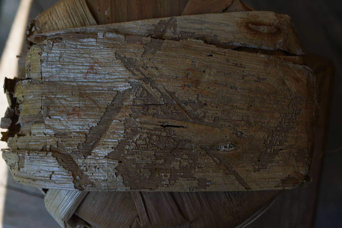 Vintage 1999 Yichang Hao Songti raw Pu-erh tea cake wrapped in original aged bamboo leaf packaging, showing natural patina and dry storage condition – Tea & Leaf.